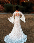 Back view of Rosaline fitted lace wedding gown with illusion back, bell sleeves and lace chapel train.