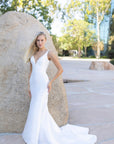 Camille clean crepe fit-and-flare wedding dress with deep V-neck at Swan Bridal San Antonio