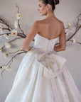Back detail of the Le Nœud strapless ball gown with a detachable oversized bow and covered buttons