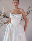 Front bodice detail of the Le Nœud strapless ball gown with a sculpted neckline and pointed basque waist
