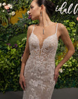 Front view of the Amélie Gown, a fitted lace wedding dress with spaghetti straps, plunging V-neckline and floral lace appliqué.