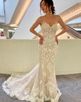 Front view of the Amélie strapless lace fit-and-flare wedding dress featuring ornate lace appliqué and a sculpted sweetheart neckline.