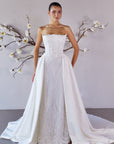 Studio front view of the Aurelia fitted lace wedding dress with two detachable train panels