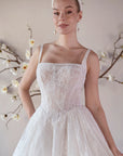 Close-up of the Elara lace A-line wedding dress with a square neckline, shoulder straps, and floral lace bodice