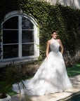 Front view of the Evangeline lace A-line wedding dress with a detachable high-neck lace topper and full skirt
