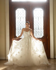 Front view of the Sovereign floral organza ball gown with a plunging V neckline and dimensional floral appliqué