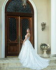 Back view of Sylvara floral A-line wedding dress with illusion bodice and flowing train