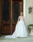 Front view of the Sylvara floral A-line wedding dress with an illusion bodice, spaghetti straps, and a flowing skirt
