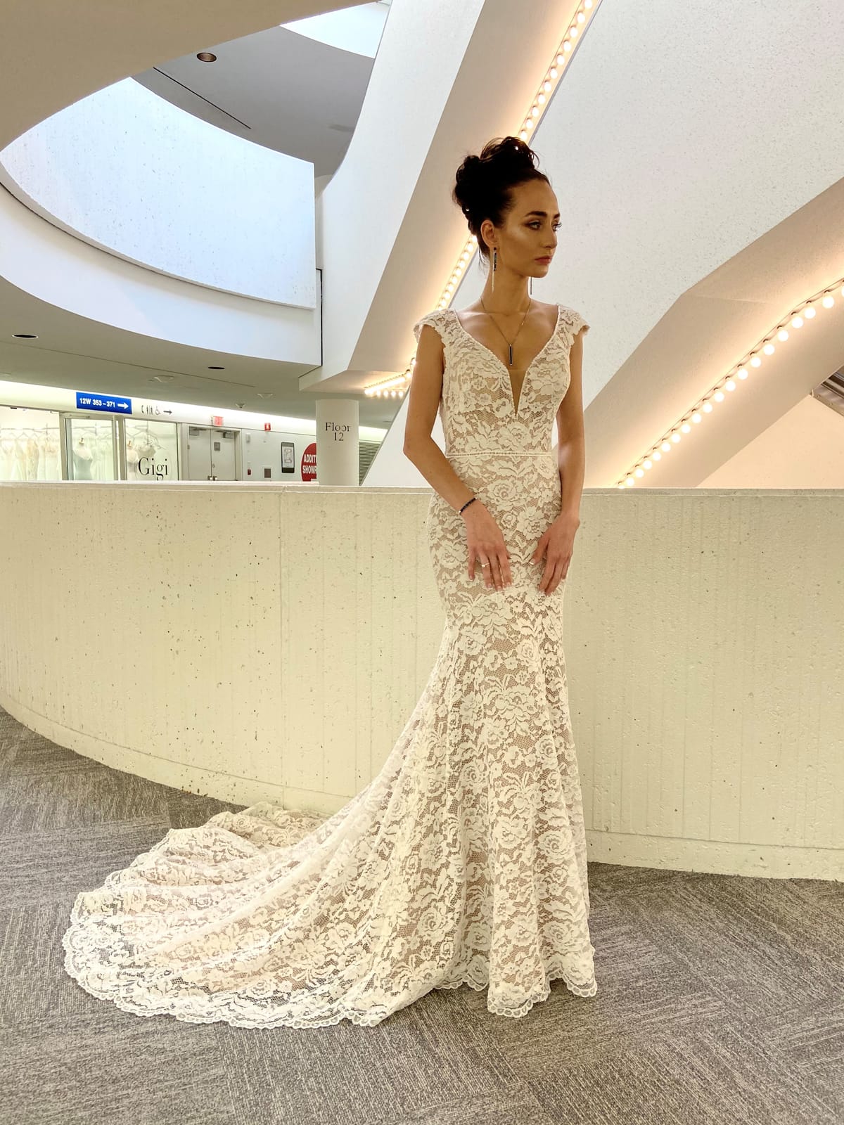 Amélie French lace fit-and-flare wedding dress with V-neckline and delicate cap sleeves at Swan Bridal.