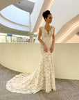 Amélie French lace fit-and-flare wedding dress with V-neckline and delicate cap sleeves at Swan Bridal.