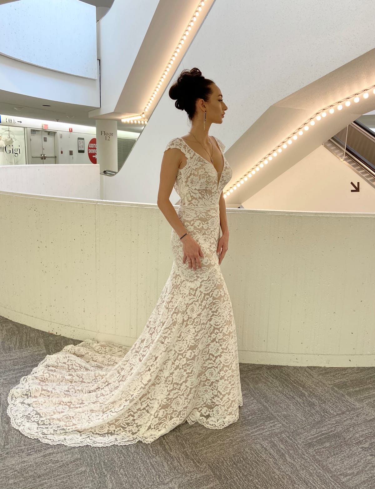 Amélie fitted lace wedding dress with cap sleeves, V-neckline and romantic chapel-length lace train.
