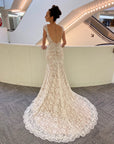 Back view of the Amélie lace wedding gown featuring a low V-back and sweeping scalloped lace train.