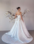 Three-quarter back view of the Le Nœud strapless ball gown with a detachable bow and voluminous train