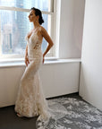 Side view of Lisette fitted floral lace wedding gown with illusion bodice details and spaghetti straps.