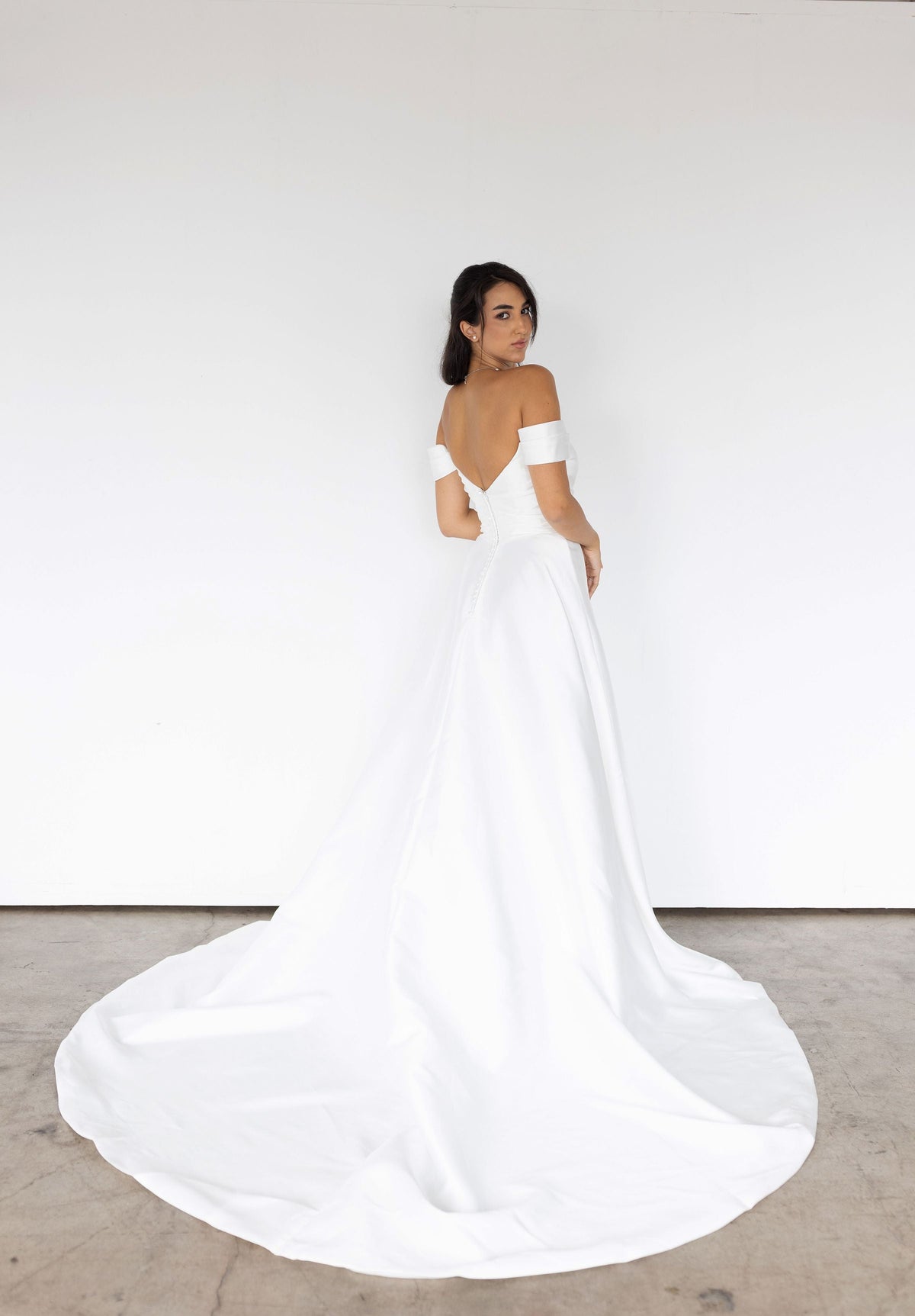 Adeline clean A-line wedding dress with off-the-shoulder back and sweeping bridal train