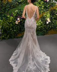 Back view of the Amélie Gown featuring a low V-back, fitted lace silhouette and long floral lace wedding dress train.