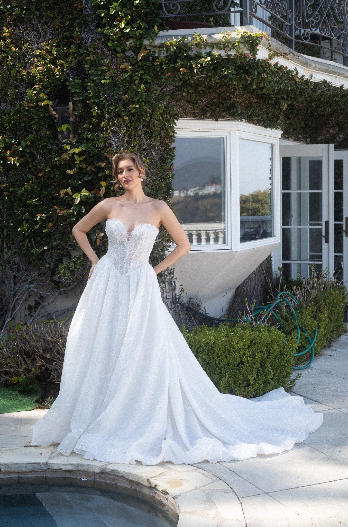 Front view of the Aurelia beaded French lace ball gown with a basque waist, full skirt, and flowing train