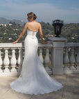 Back view of the Aurelia fitted lace wedding dress with a lace-up corset and flowing lace train