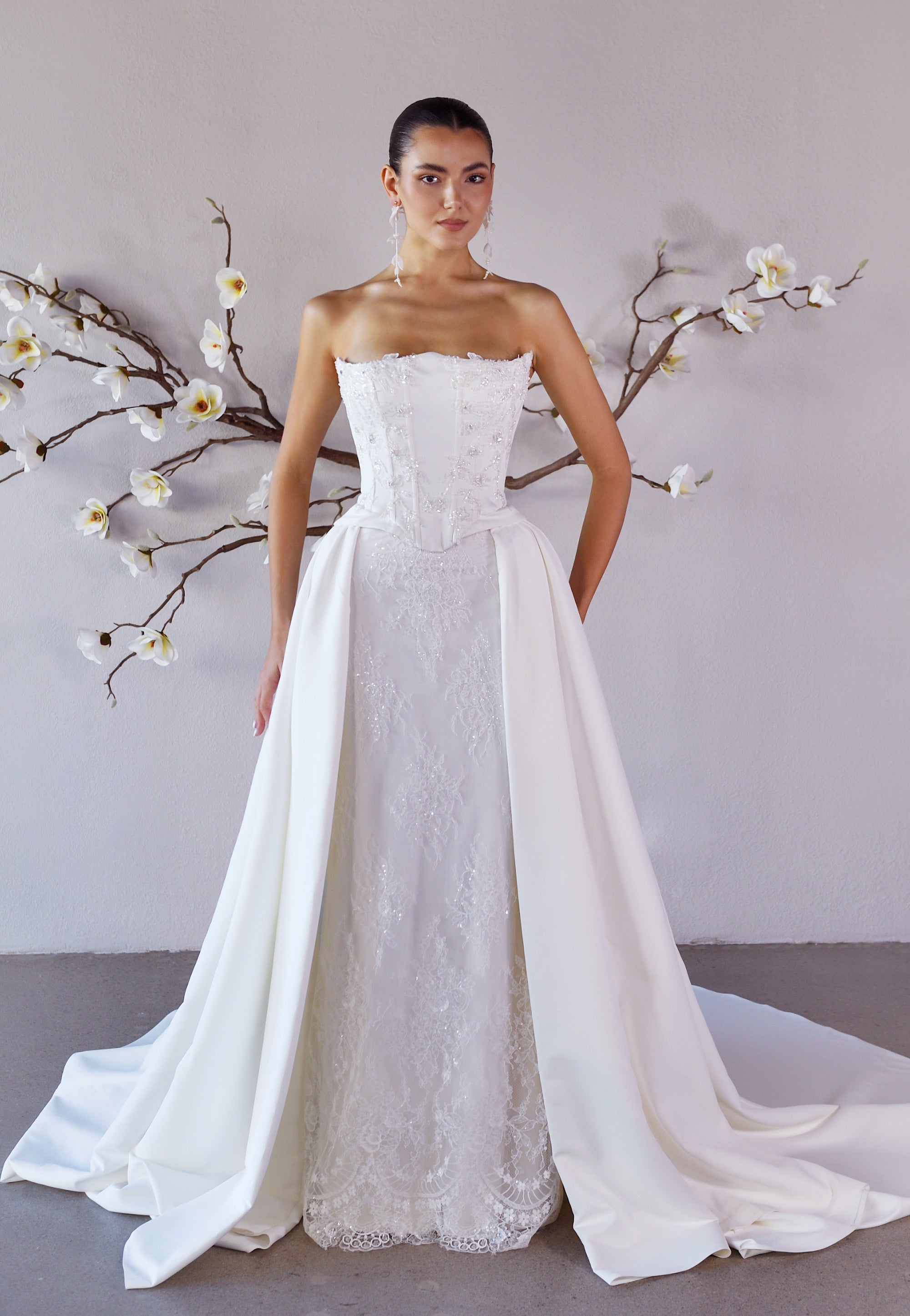 Studio front view of the Aurelia fitted lace wedding dress with two detachable train panels