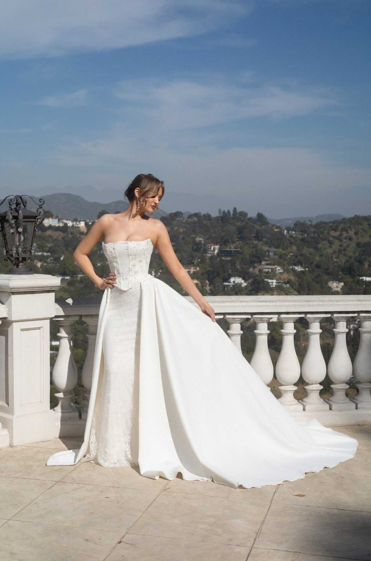 Front view of the Aurelia fitted lace wedding dress with two detachable train panels