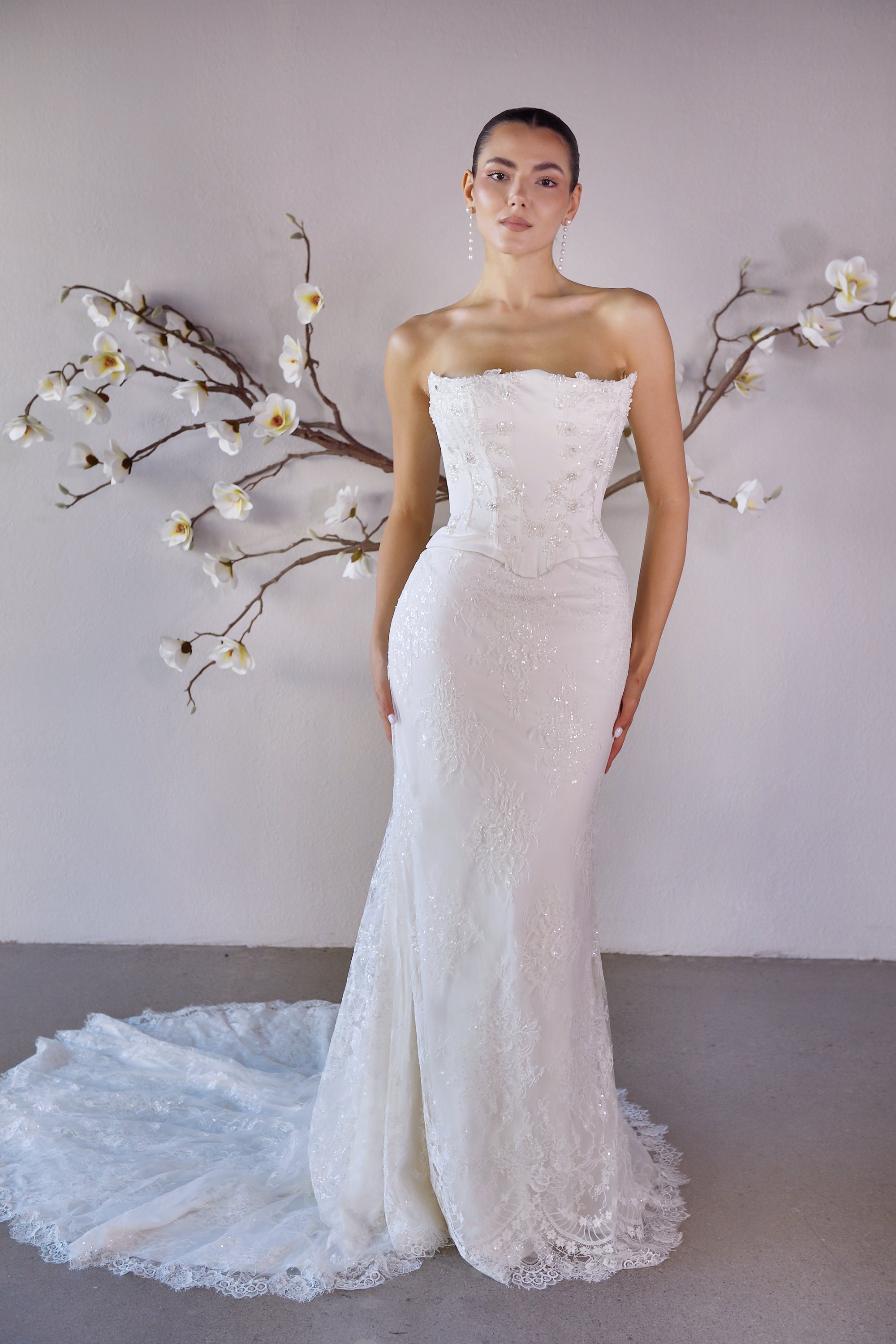 Front view of the Aurelia fitted strapless lace wedding dress without the detachable train panels