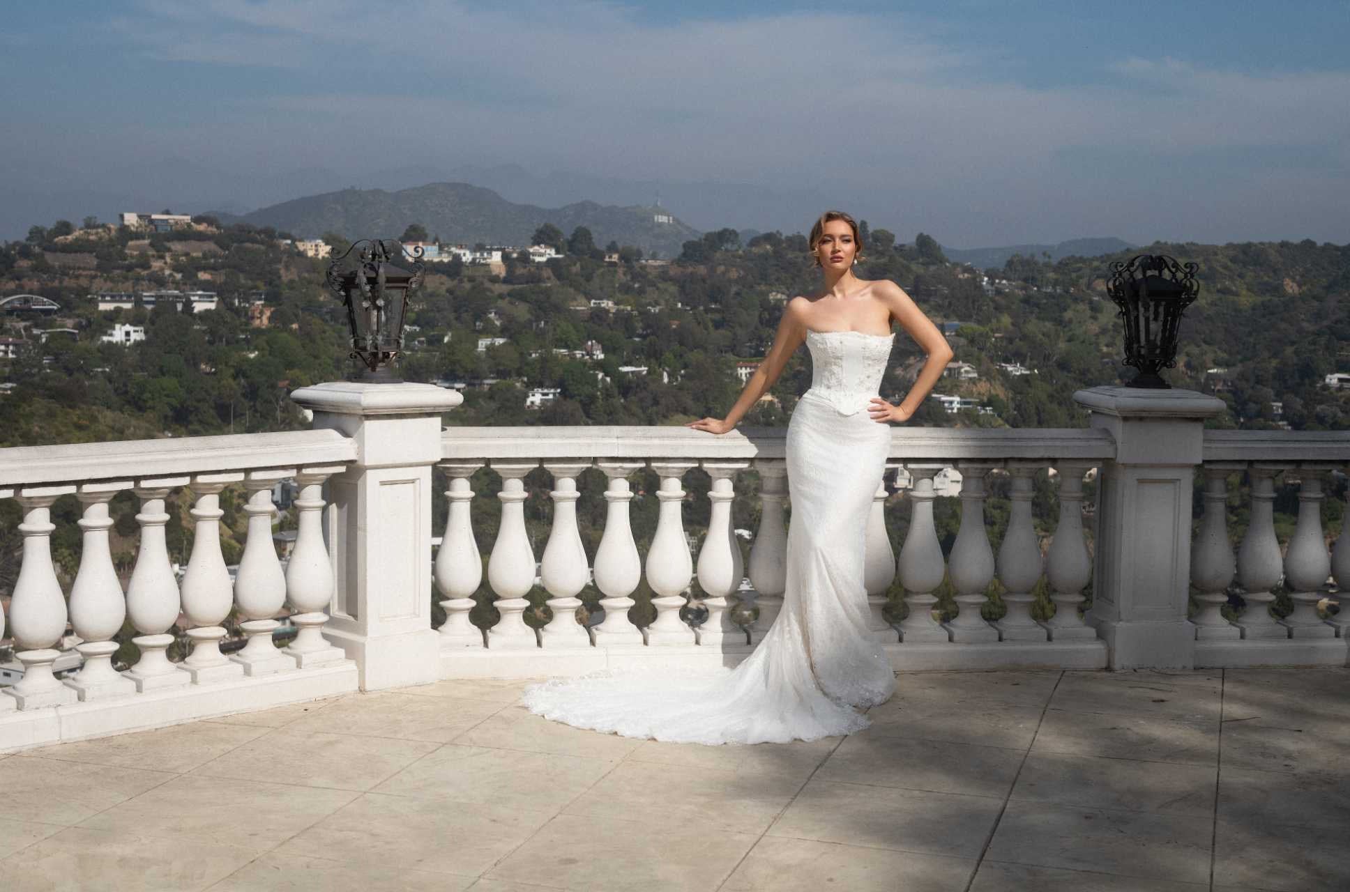 Front view of the Aurelia fitted strapless lace wedding dress without the detachable train panels