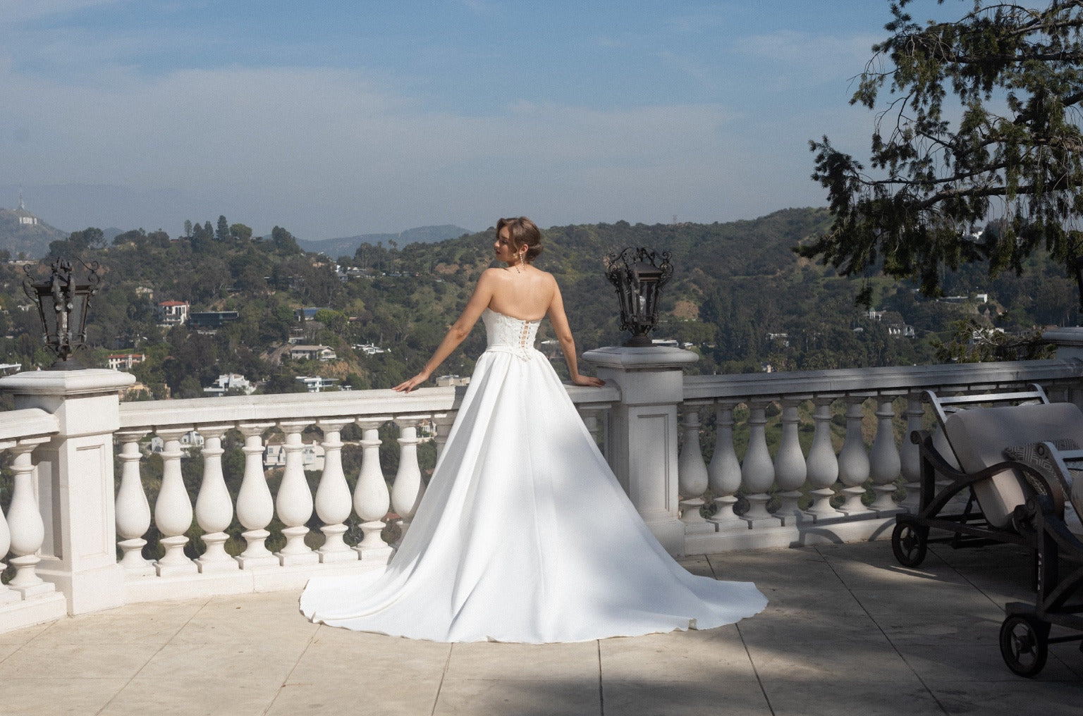 Back view of the Aurelia fitted wedding dress with two detachable train panels and a sweeping train