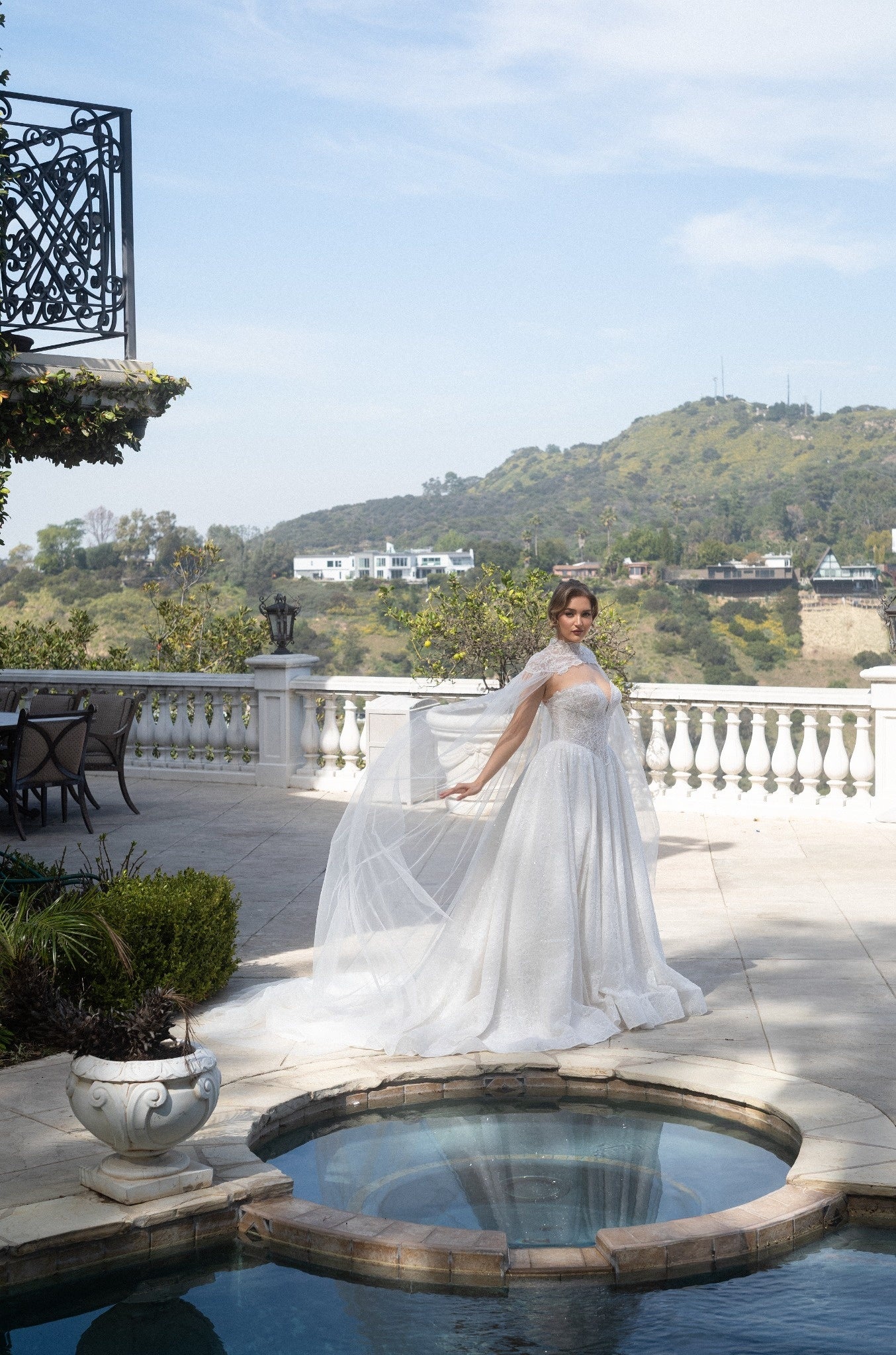 Full front view of the Aurelia French lace ball gown with a detachable tulle cape, corset bodice, and voluminous skirt