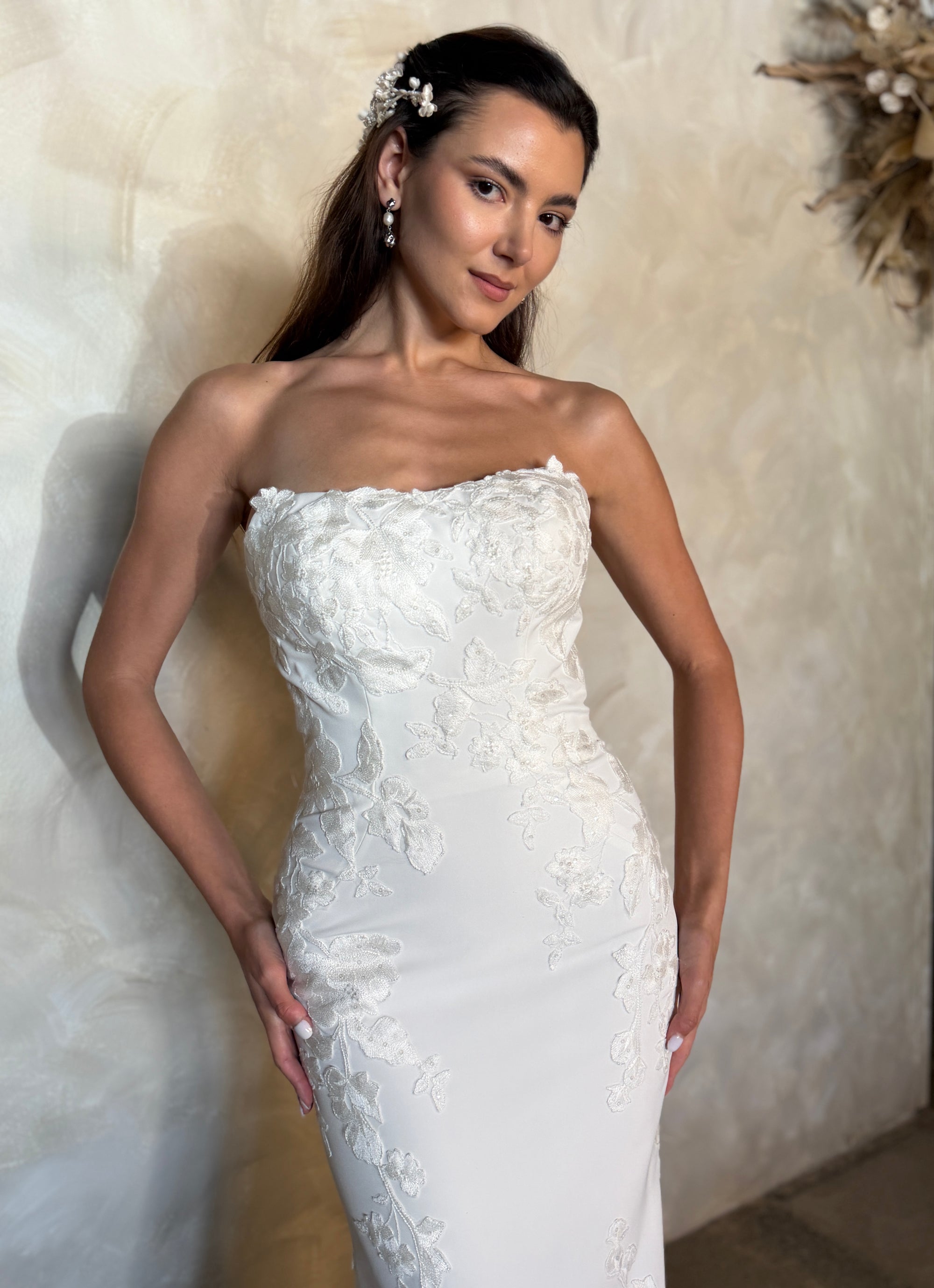 Close-up of the Aveline fitted strapless wedding dress with dimensional floral lace appliqué