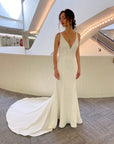 Front view of the Bliss Gown, a minimalist fitted wedding dress with a deep V-neckline and clean silhouette.