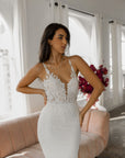 Close-up of the Camille Gown featuring floral lace appliqué, an illusion plunging neckline and delicate lace straps.
