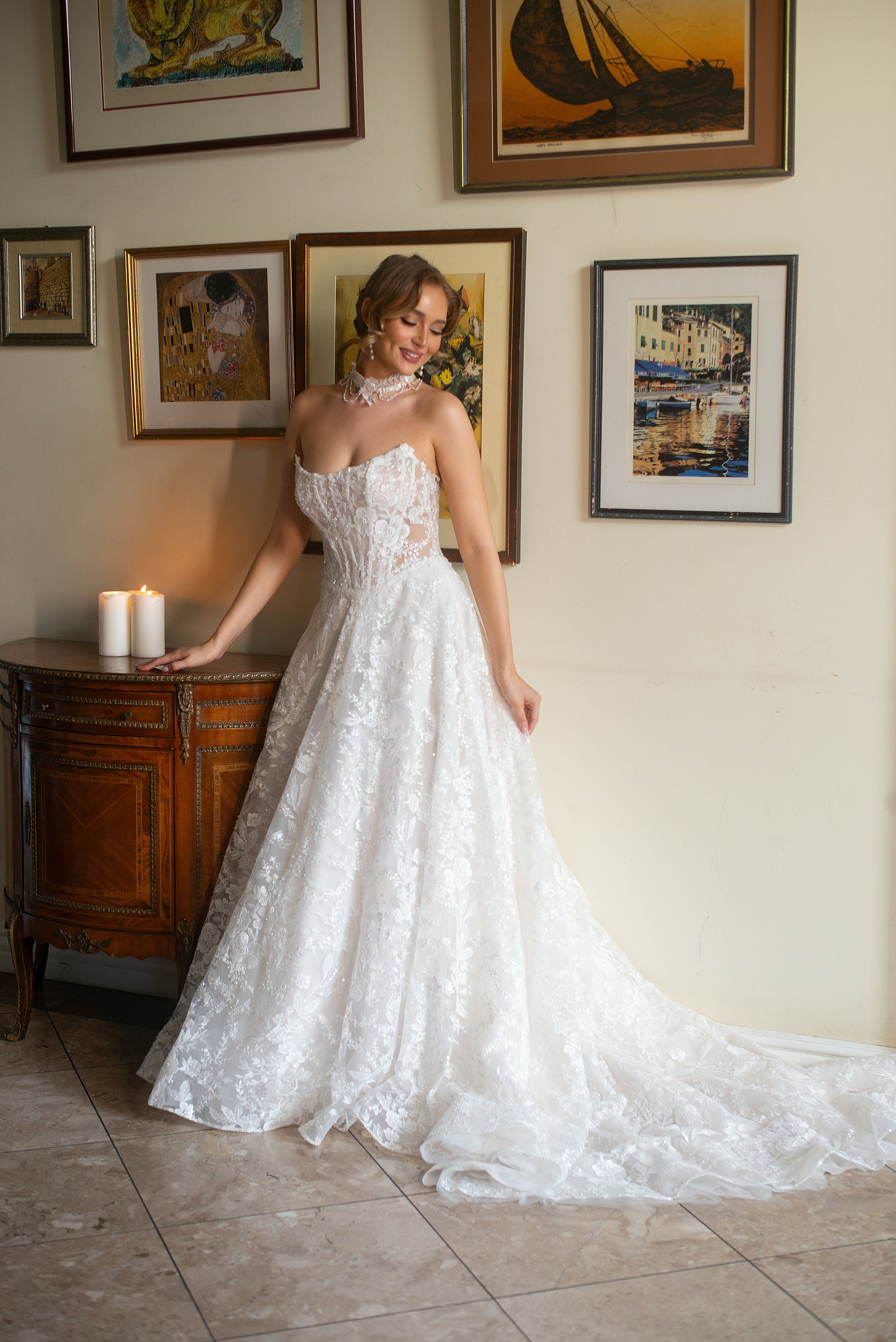 Front view of the Celestia strapless lace A-line wedding dress with a sweetheart neckline and long flowing train