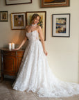 Front view of the Celestia strapless lace A-line wedding dress with a sweetheart neckline and long flowing train
