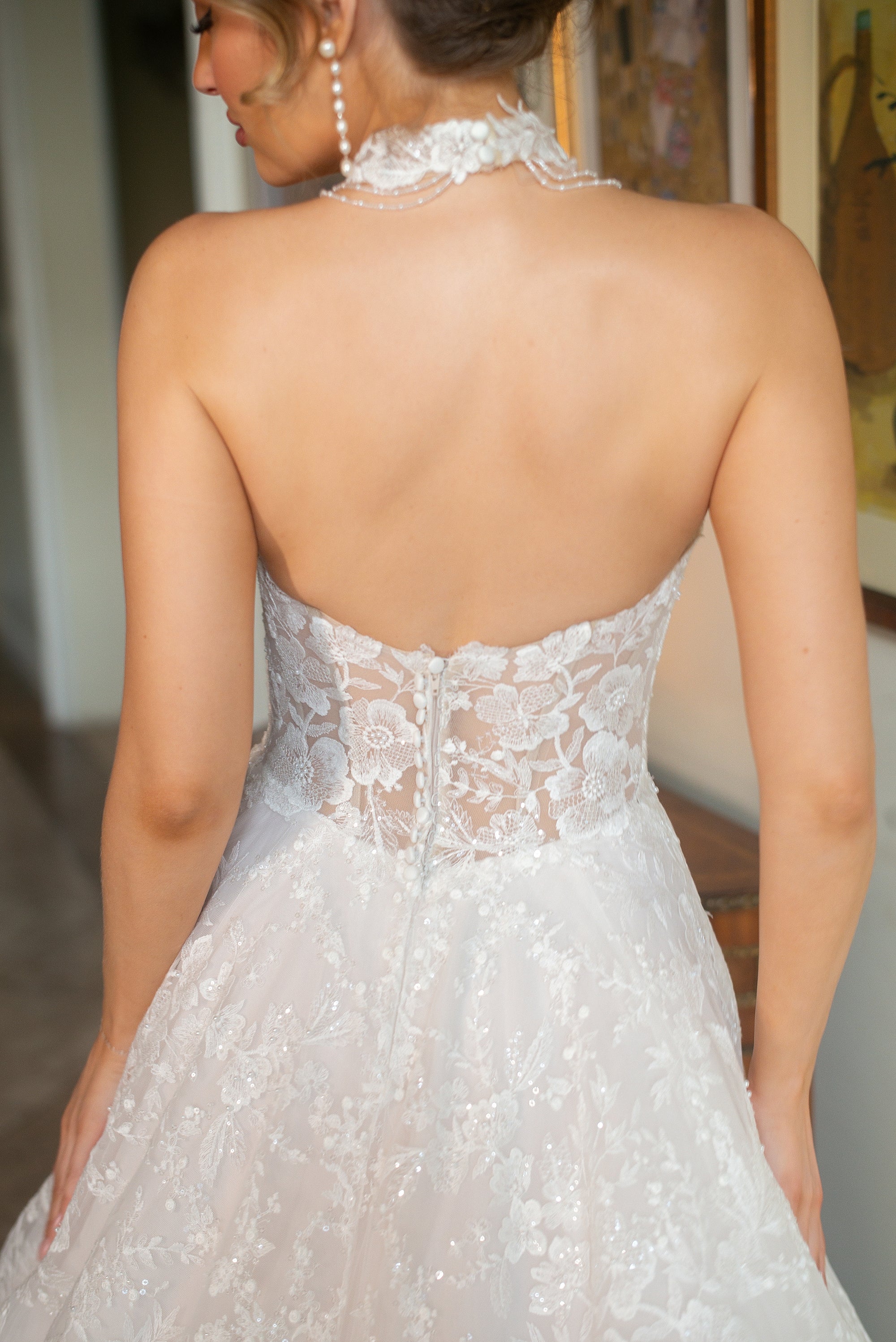 Back detail of the Celestia strapless lace A-line wedding dress with a low sheer corset bodice and floral lace