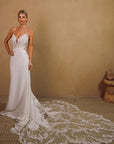 Elara clean fitted wedding dress with plunging neckline and dramatic floral lace train at Swan Bridal