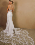 Back view of the Elara open back fitted wedding dress with floral lace appliqué and dramatic lace train