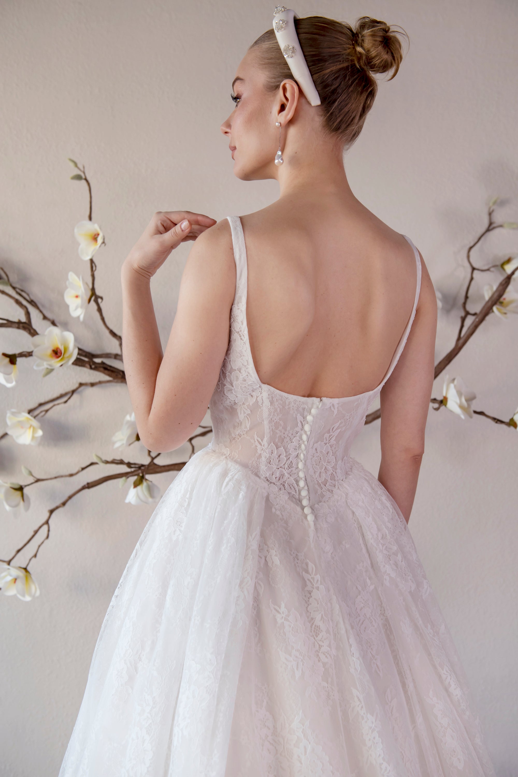 Back bodice detail of the Elara lace A-line wedding dress with a low scoop back and covered buttons