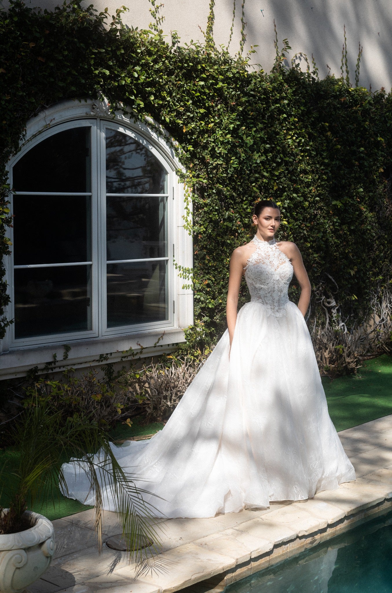 Front view of the Evangeline lace A-line wedding dress with a detachable high-neck lace topper and full skirt