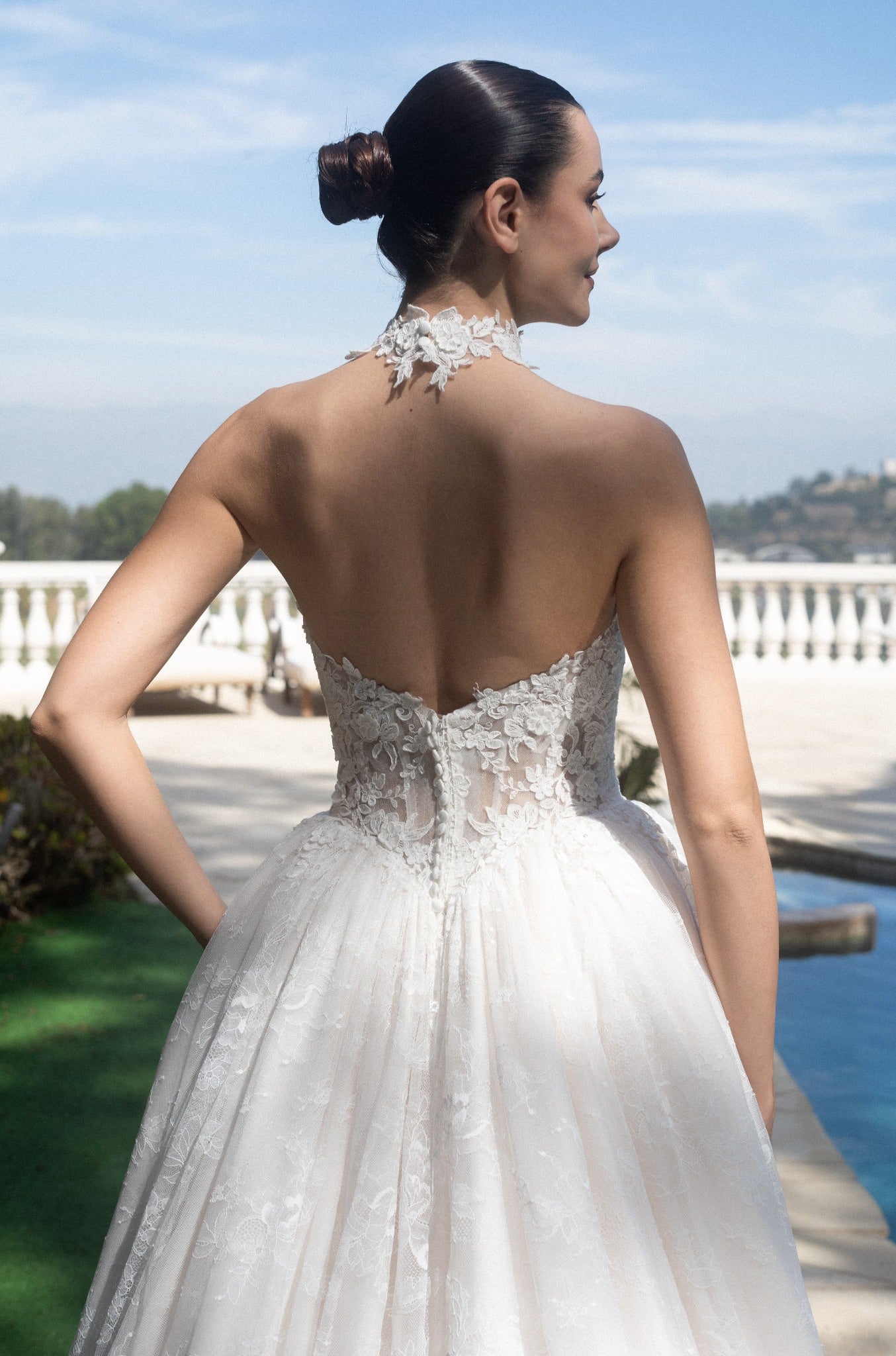 Back bodice detail of the Evangeline wedding dress with a detachable lace halter topper and low back