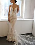 Lisette lace fit-and-flare wedding dress with spaghetti straps, plunging neckline and floral lace train at Swan Bridal San Antonio.