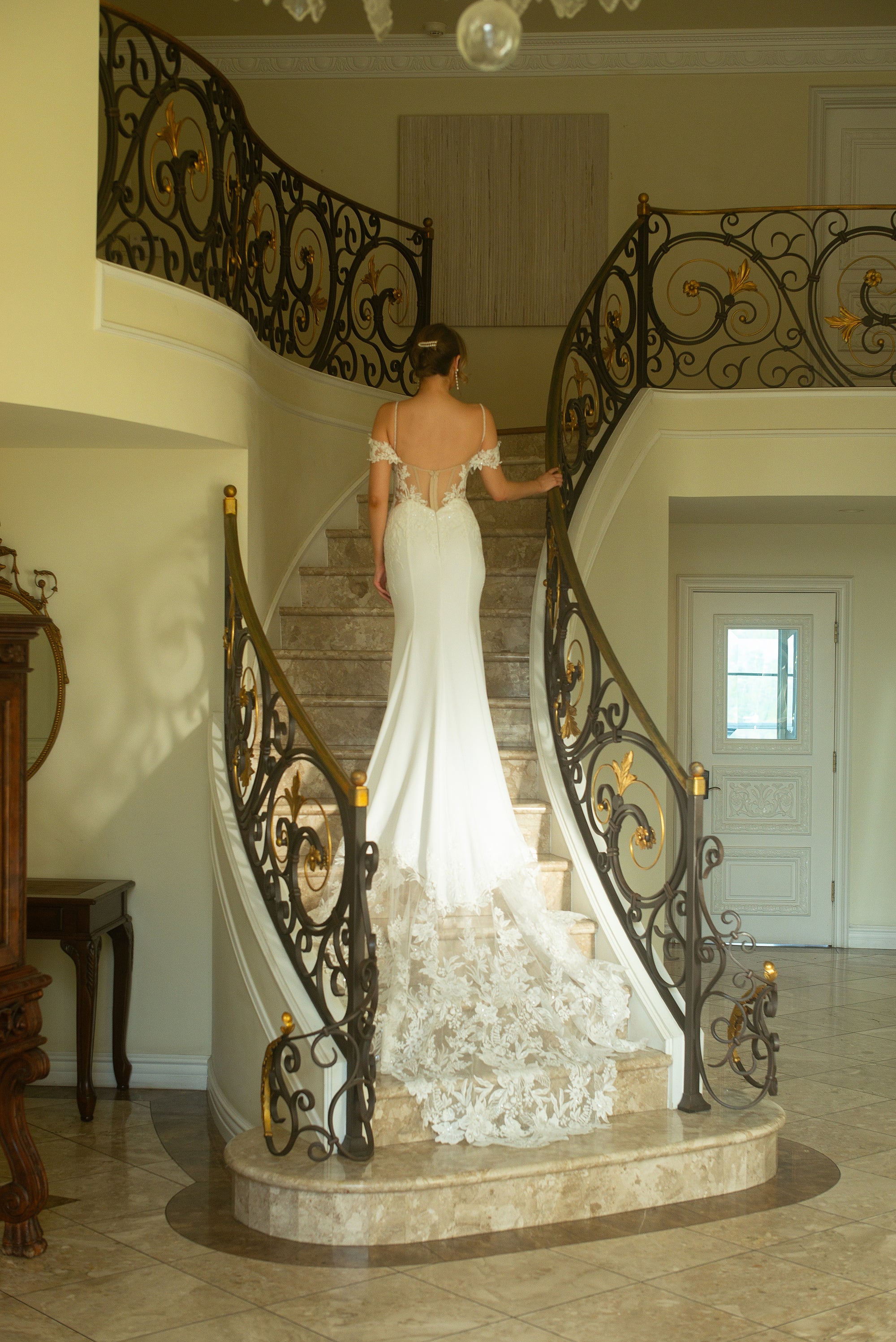 Full back view of the Giardino fitted crepe wedding dress with a low illusion back and sweeping floral lace train