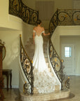 Full back view of the Giardino fitted crepe wedding dress with a low illusion back and sweeping floral lace train