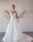 Front view of the Isolde strapless lace ball gown with a structured corset bodice, basque waist, and full skirt