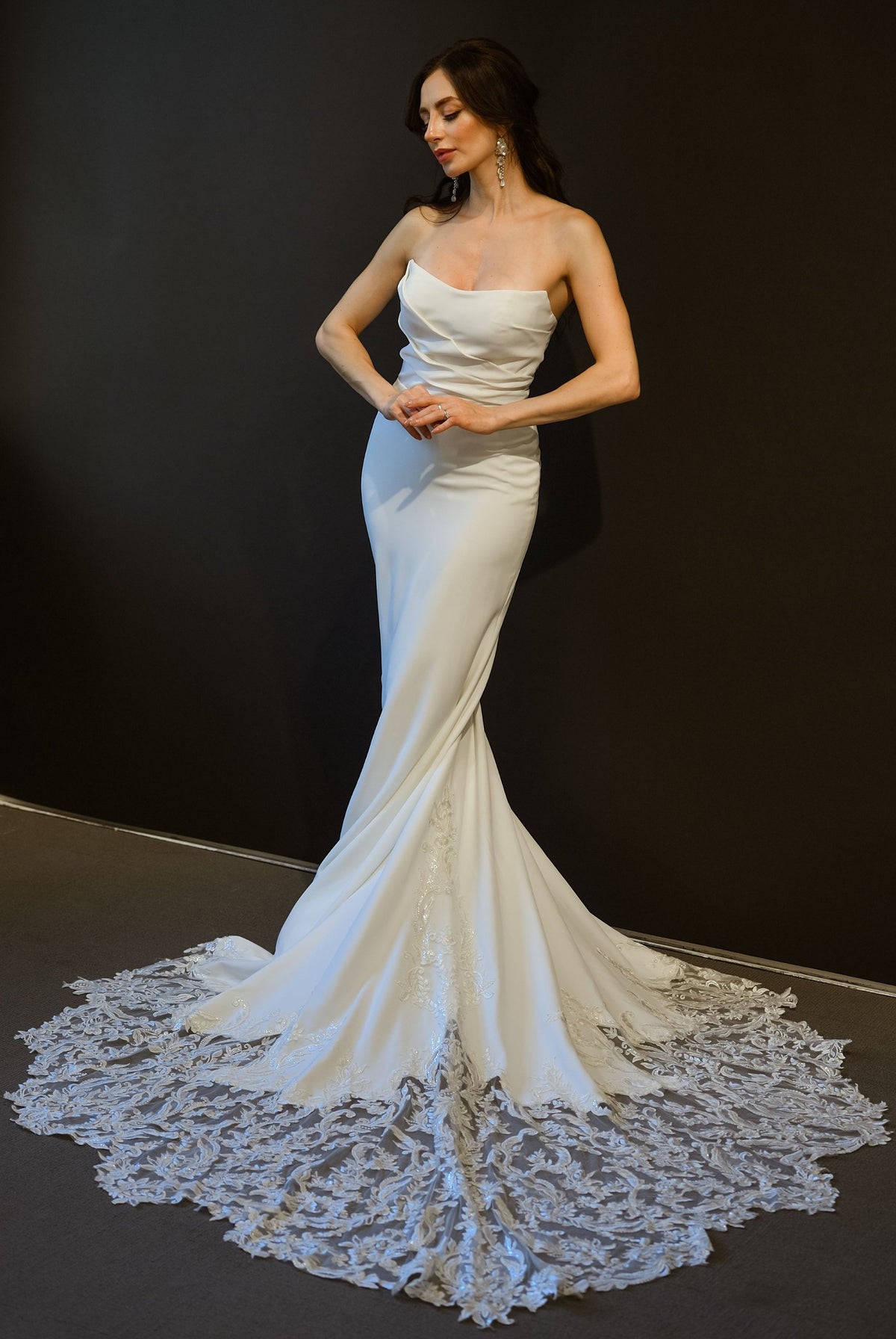 Odette clean fitted wedding dress with asymmetrical neckline and lace statement train at Swan Bridal San Antonio