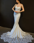 Odette clean fitted wedding dress with asymmetrical neckline and lace statement train at Swan Bridal San Antonio