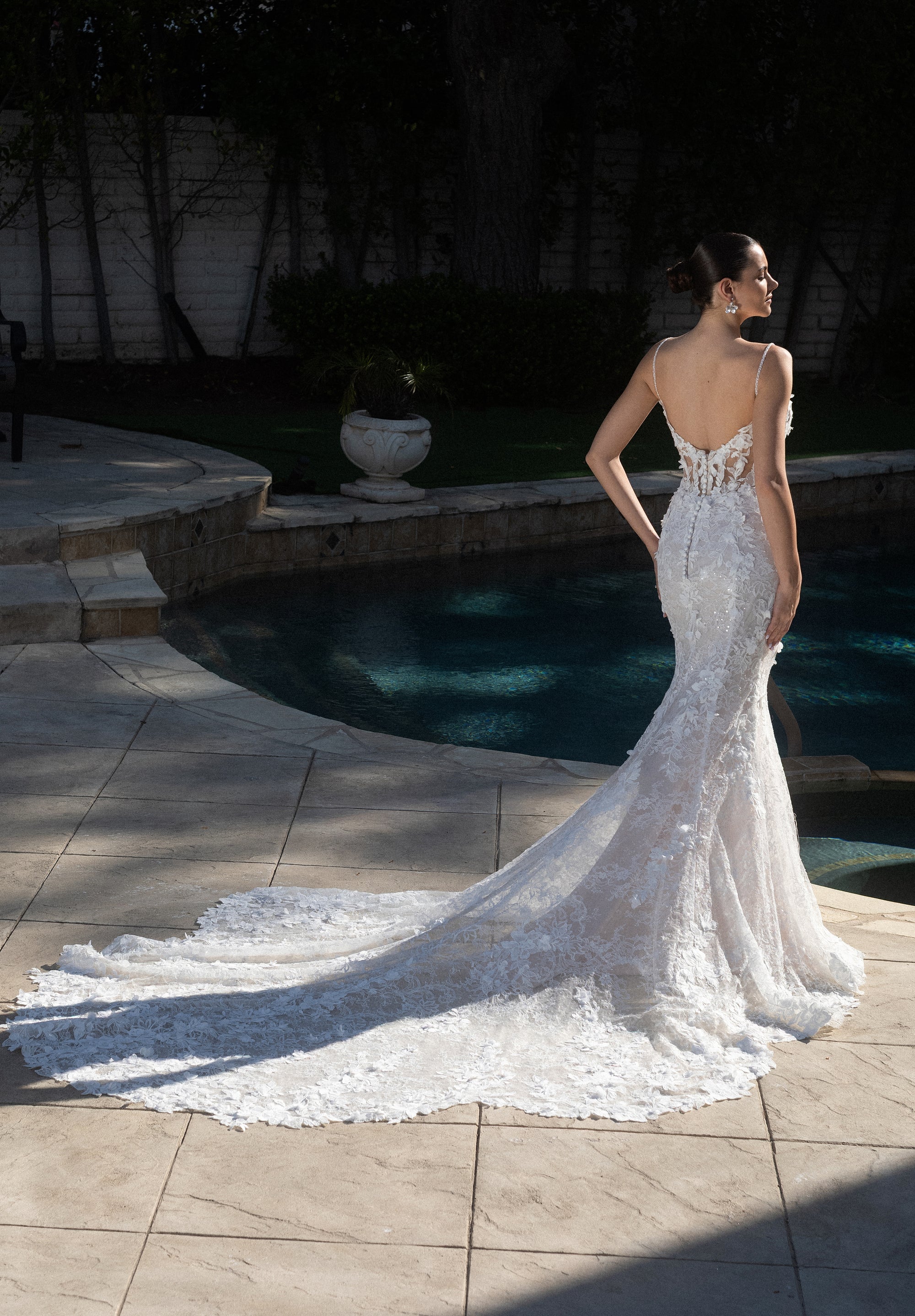 Full back view of the Seraphine 3D floral French lace fit-and-flare wedding dress with a low back and dramatic lace train