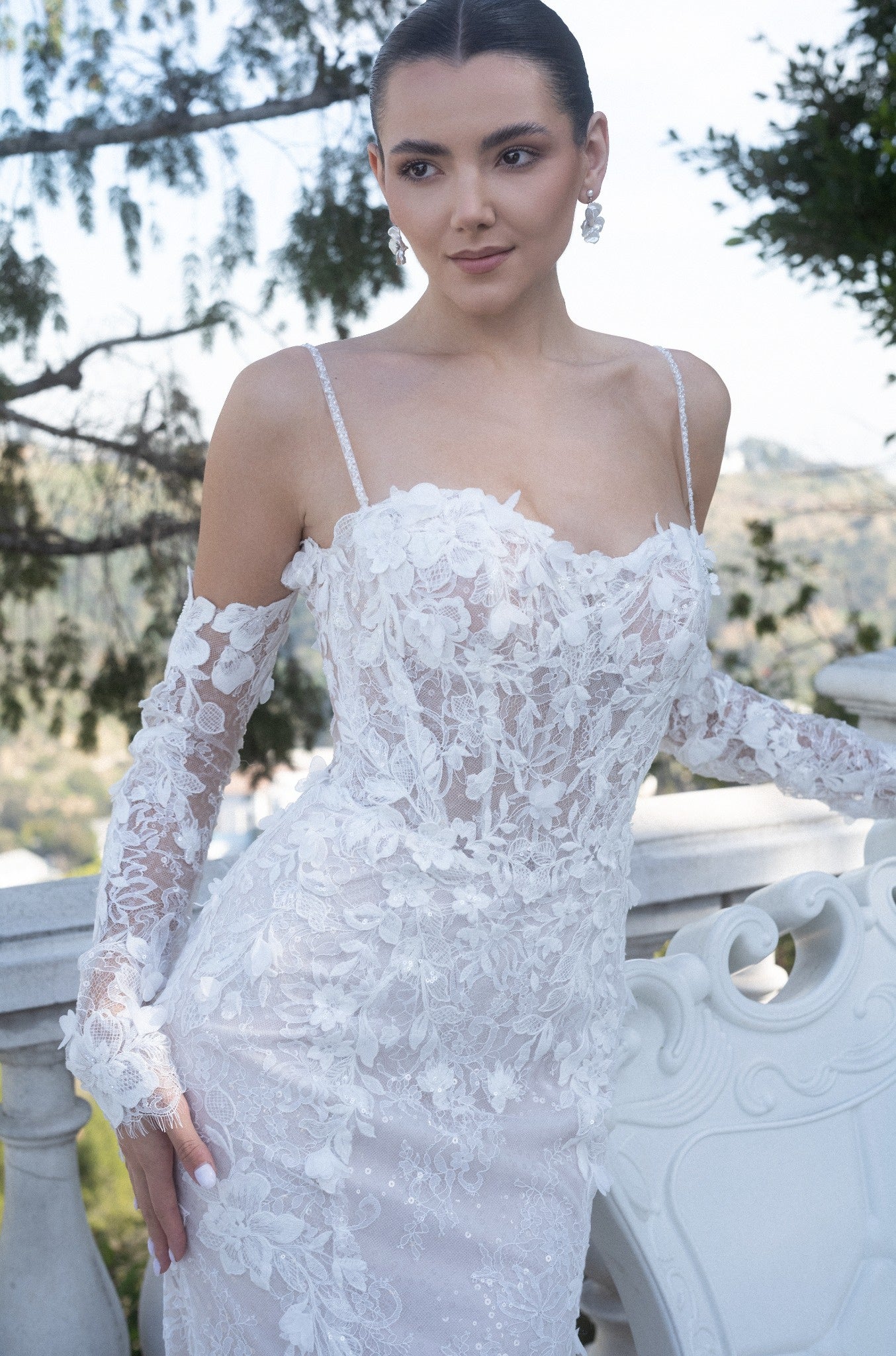 Close-up of the Seraphine 3D floral French lace fit-and-flare wedding dress with a sheer corset bodice and detachable off-the-shoulder sleeves