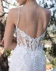 Back bodice detail of the Seraphine 3D floral lace wedding dress with a low illusion back, covered buttons, and delicate sequins