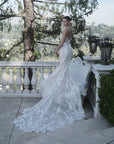 Three-quarter back view of the Seraphine 3D floral lace wedding dress with a fit-and-flare silhouette, subtle sequins, and flowing train