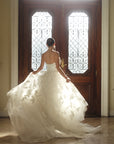 Back view of the Sovereign floral ball gown in motion with a voluminous organza skirt and sweeping train
